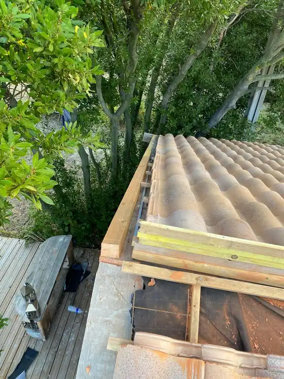 Appentis en cours de couverture, chevrons neufs apparents